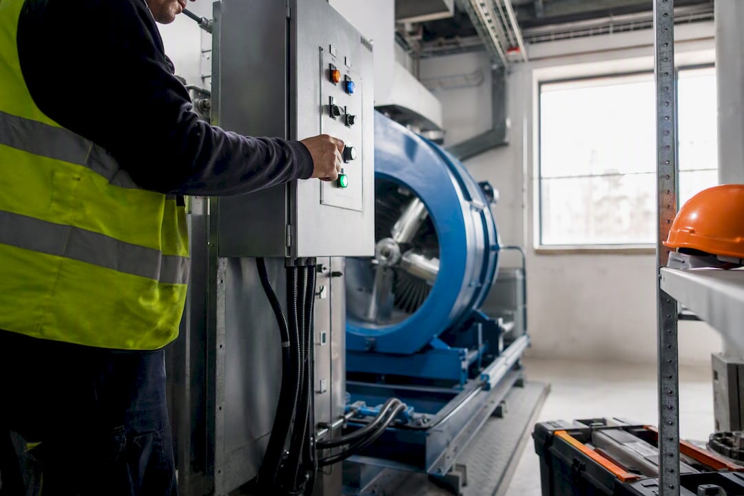Technician testing smoke control fan operation