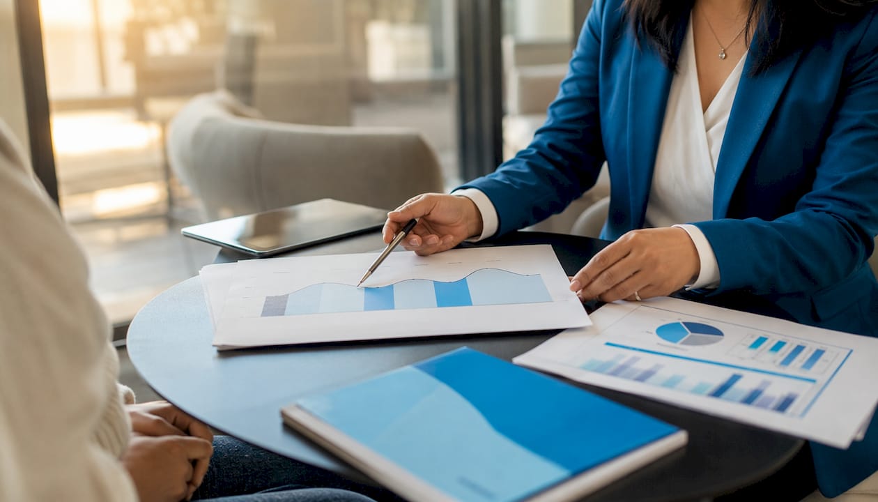 Advisor explaining mortgage payment cycle with documents