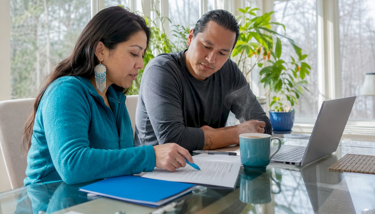 Couple reviewing mortgage application at kitchen island
