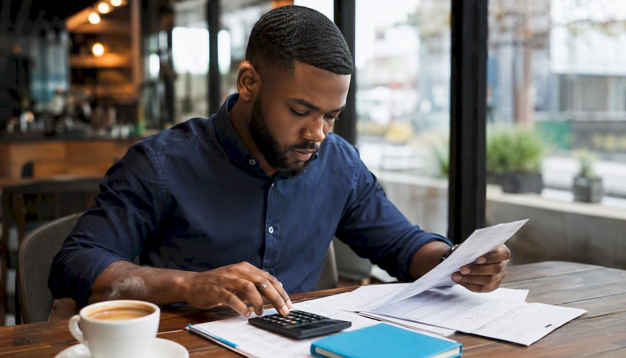 Underwriter sorting mortgage documents hands close-up