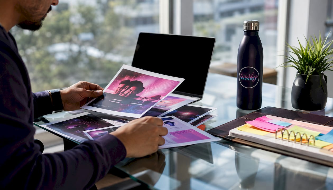 Best Music Marketing Agencies for Independent Musicians - 1784445123787 Hands organizing music marketing materials on desk Hands organizing music marketing materials on desk