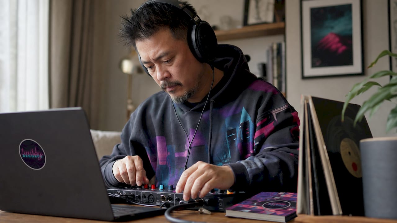 Home Studio Mixing: A 2026 Guide for Independent Musicians - 1784561687303 Man mixing music using headphones and laptop in home studio Man mixing music using headphones and laptop in home studio
