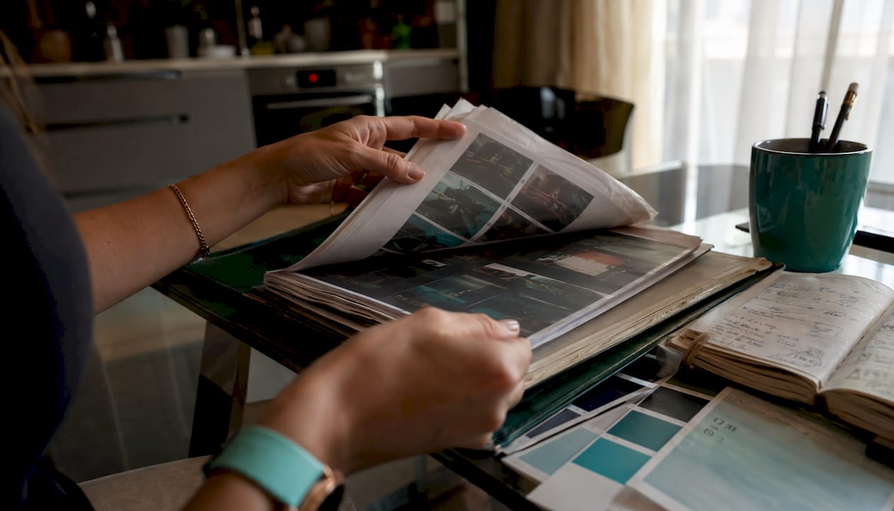 Hands reviewing video style guides and thumbnails
