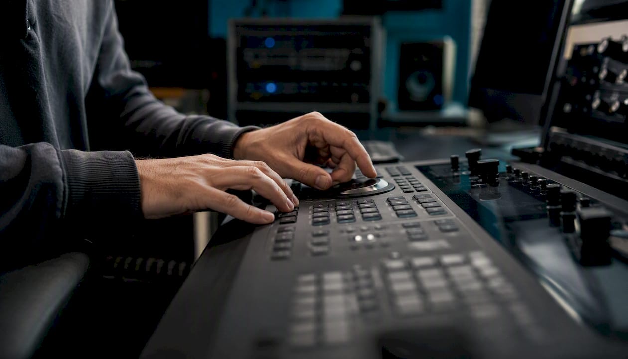 Hands cutting video clip on editing controller