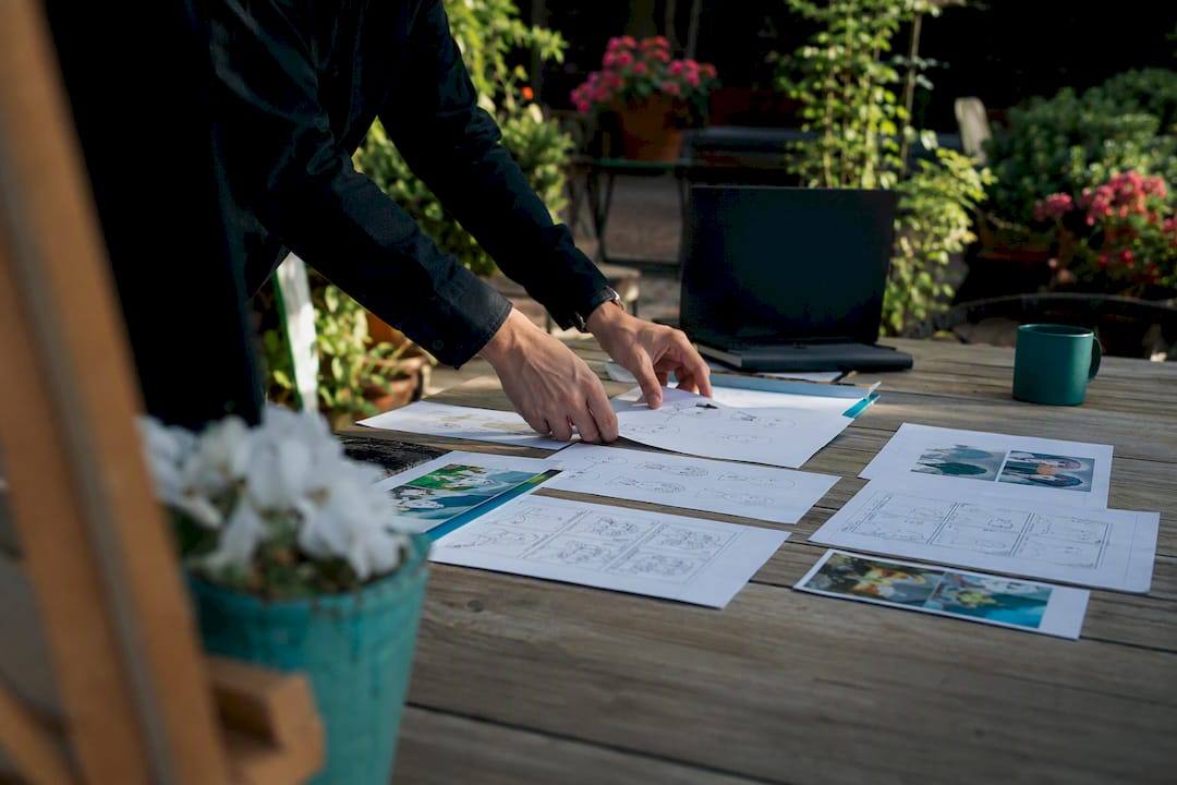 Hands arranging storyboards on desk