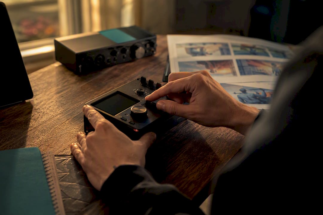 Hands adjusting metadata label on digital recorder