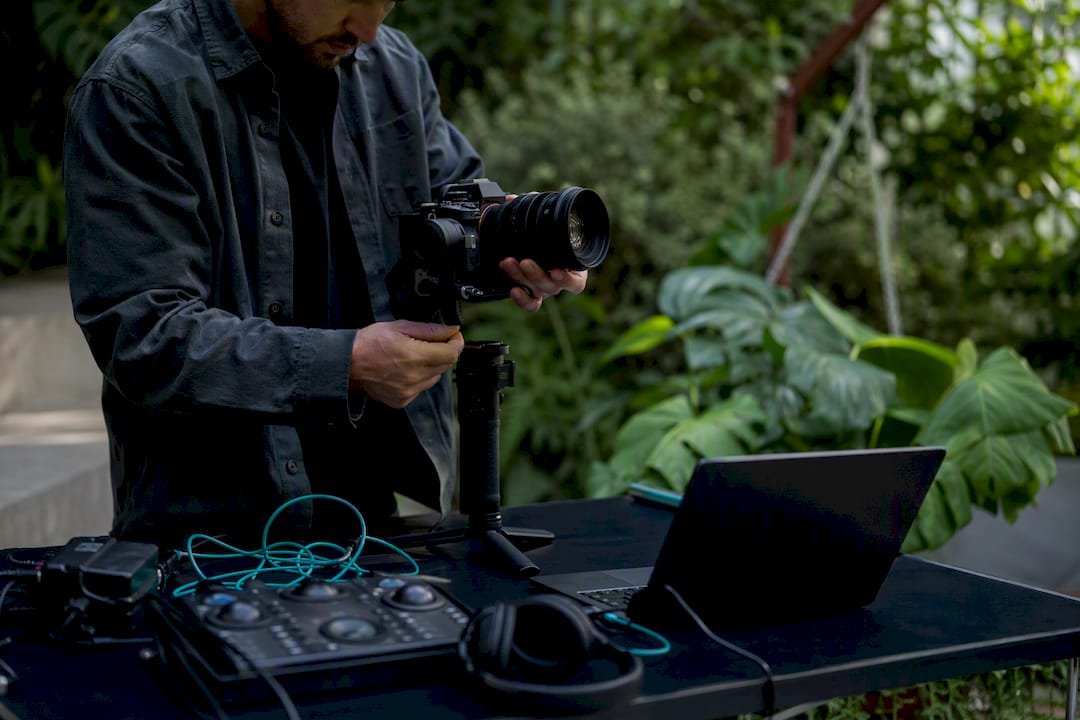 Hands adjusting video production camera gear