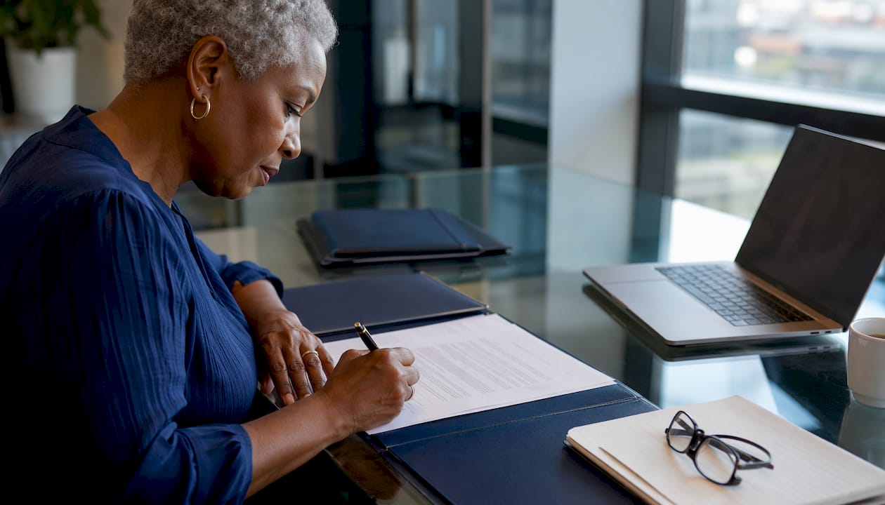 Close-up of hands signing legal charge form