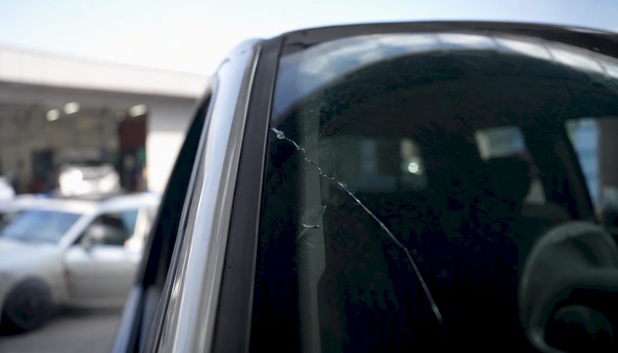 Close-up of windshield stress crack compromising safety