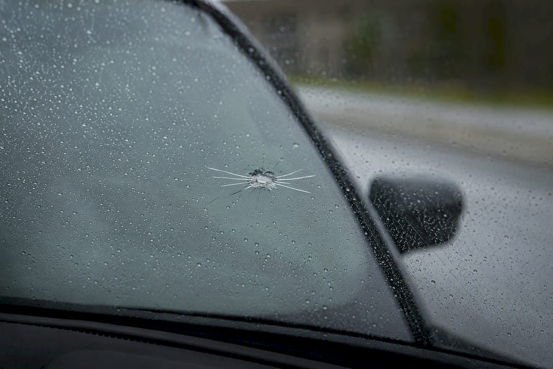 Cracked windshield close-up with rock impact
