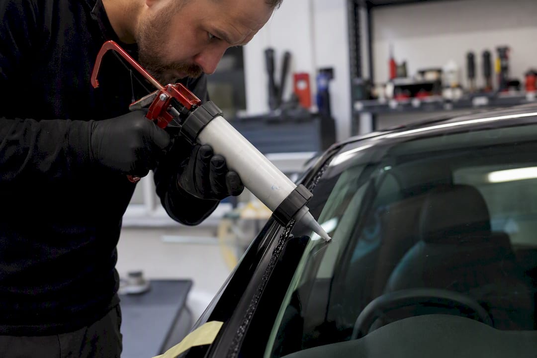 Close-up of primerless adhesive bead on windshield edge