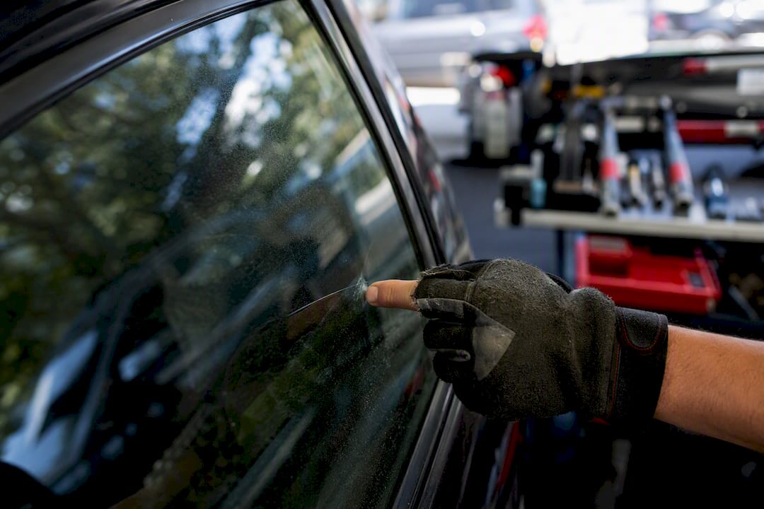 Technician fingernail testing scratch on side window