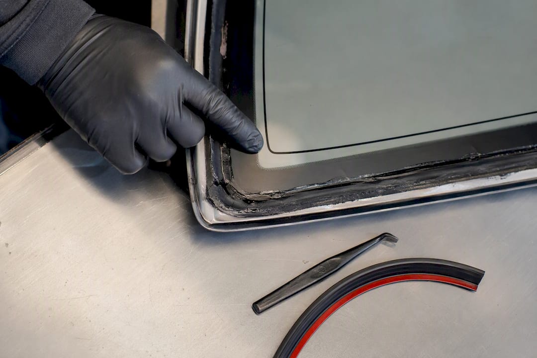 Technician inspecting windshield urethane bead