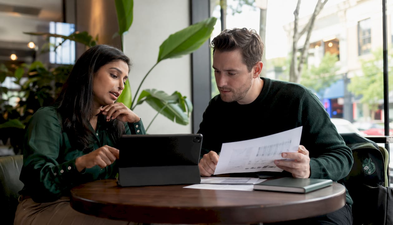 Colleagues discussing betting data in office