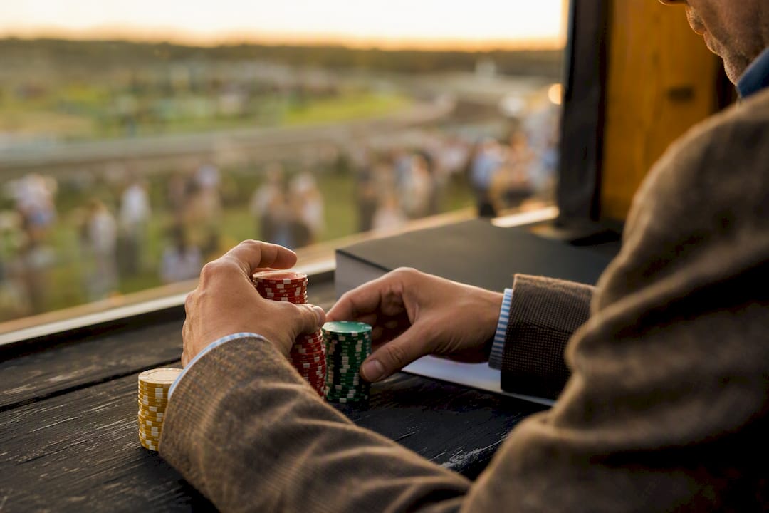 Hands stacking betting chips with discipline