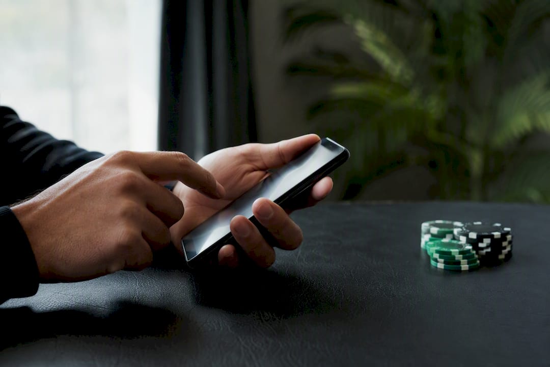Hand entering bet amounts on mobile calculator