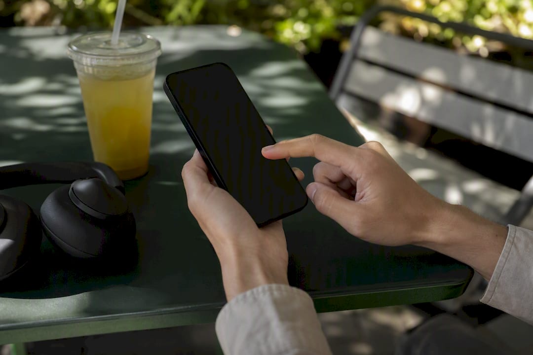 Hands adjusting alert settings on smartphone