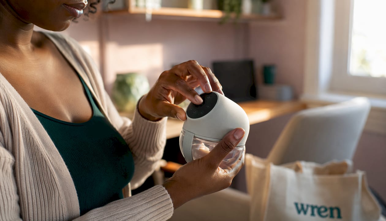 Close-up of hands using wearable breast pump