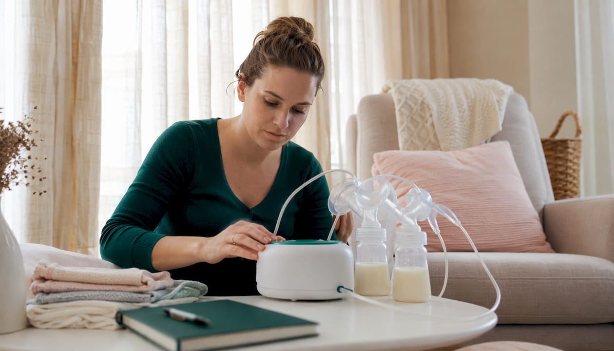 Woman adjusting hospital-grade breast pump in nursery