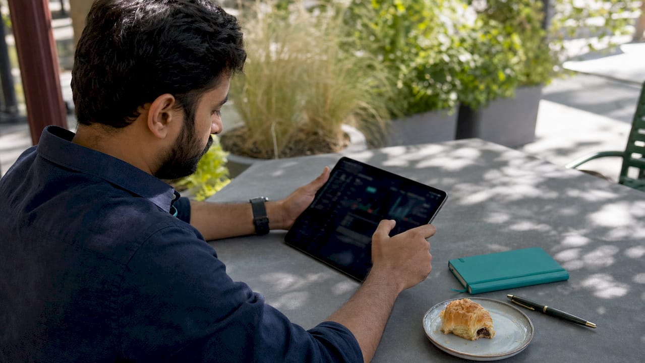 Man analyzing AI personalization data on tablet