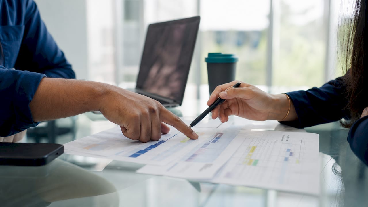 Hands reviewing touch spacing in sales cadence plan