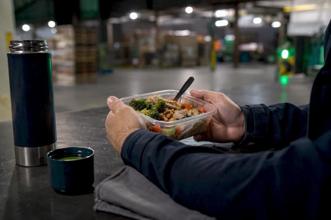 Hands holding protein meal during night shift break
