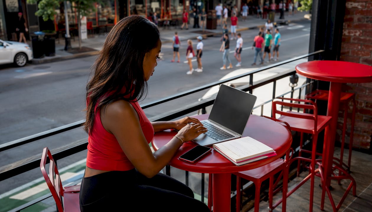 Woman typing Twitter thread in home office