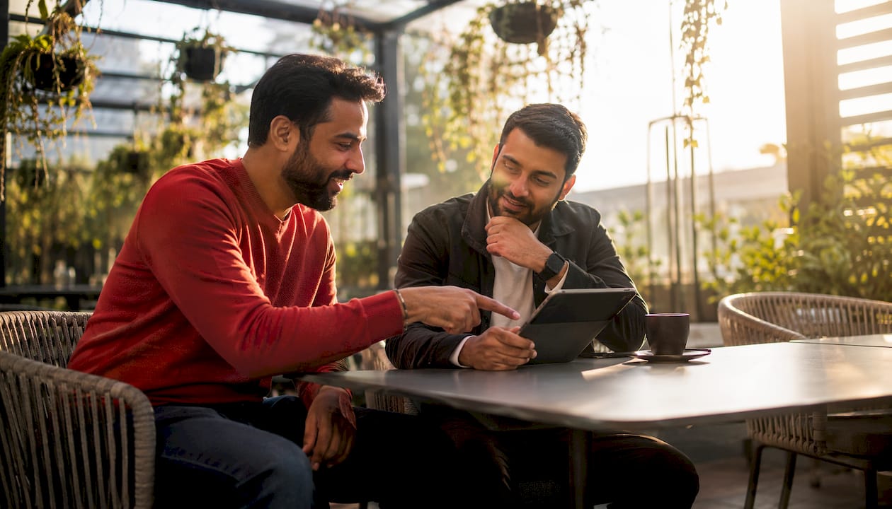 Two men discussing campaign content collaboration