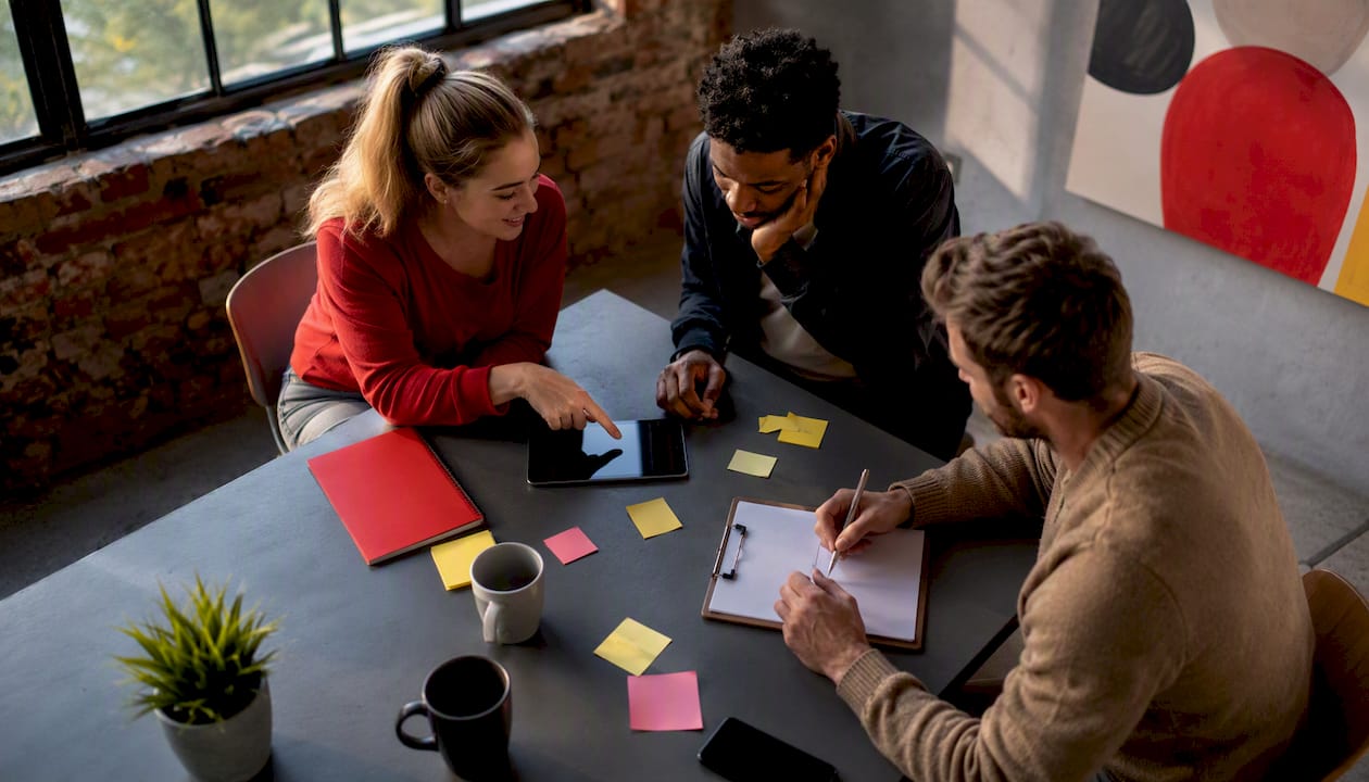 Marketing team discussing brand monitoring tools
