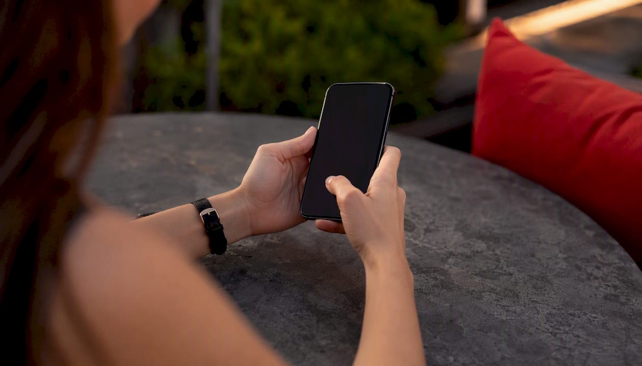 Hands typing affiliate code on smartphone