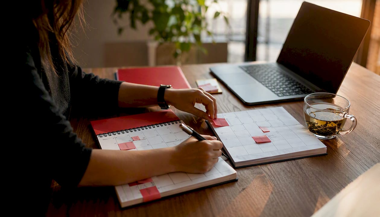 Hands planning social media launch timetable