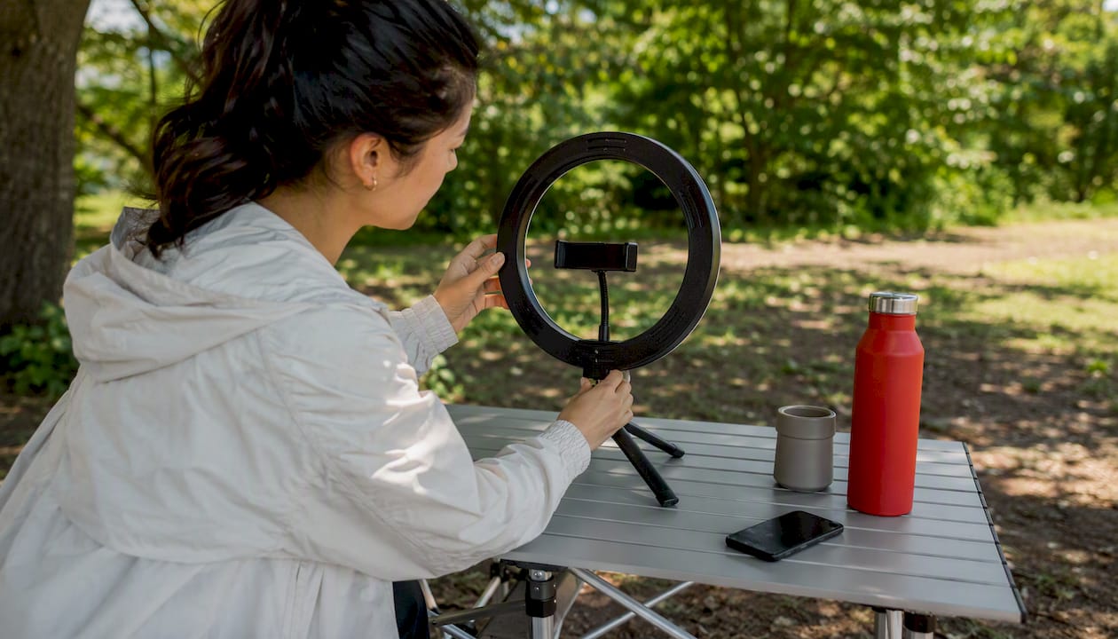 Hands adjusting influencer video setup equipment