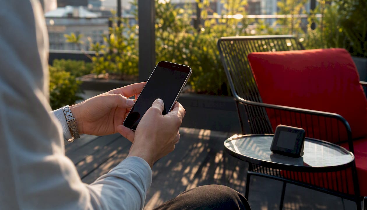 Marketer's hands holding smartphone in office
