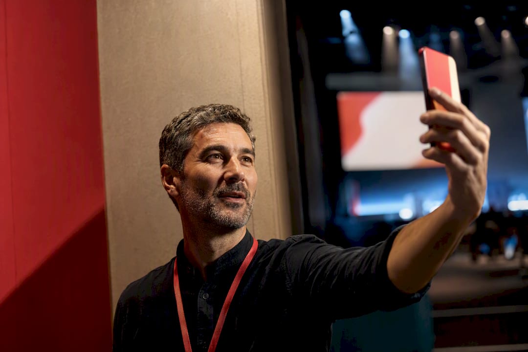Speaker recording selfie video backstage