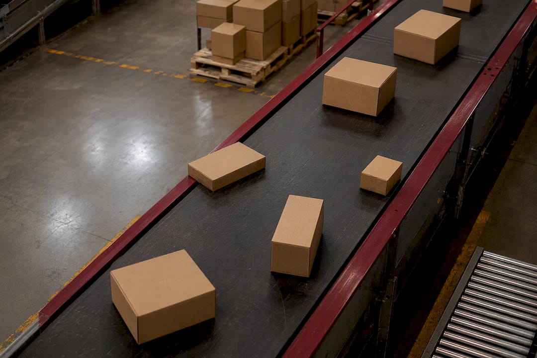 Plain parcels moving on conveyor belt
