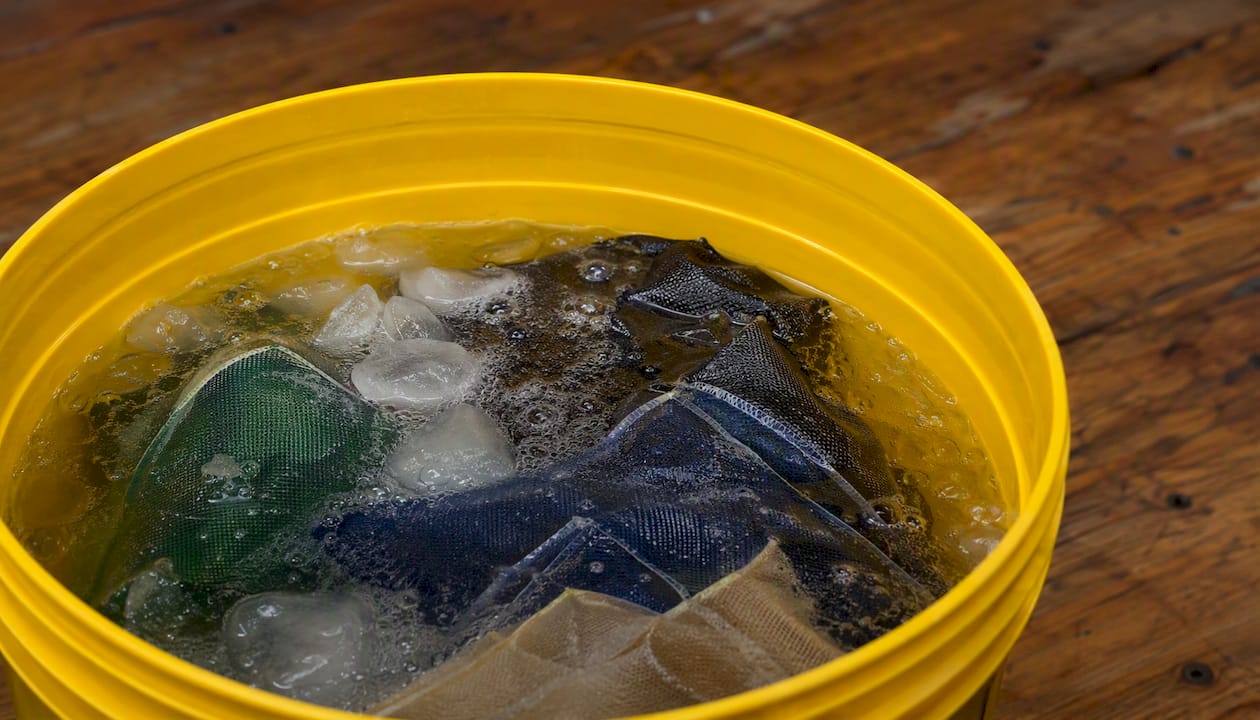 Bubble hash filter bags in ice water bucket