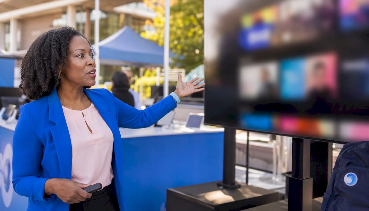 Presenter showcasing smart TV technology
