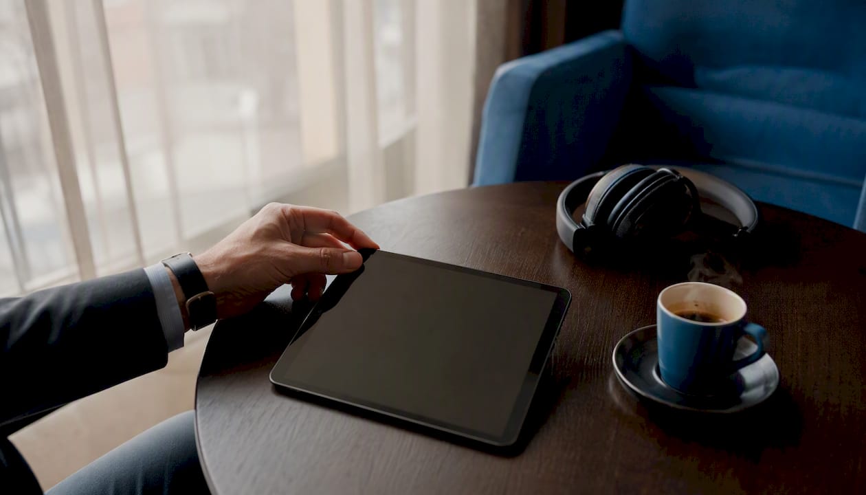 Hand adjusting talent usage contract on tablet