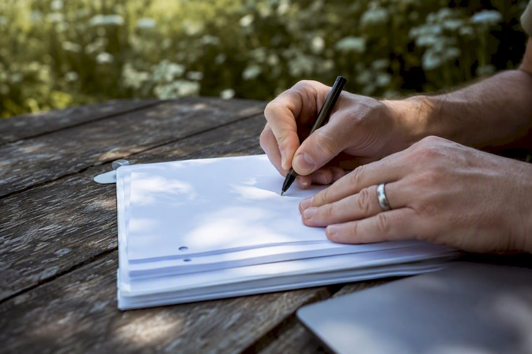 Hands marking script margins for clearance