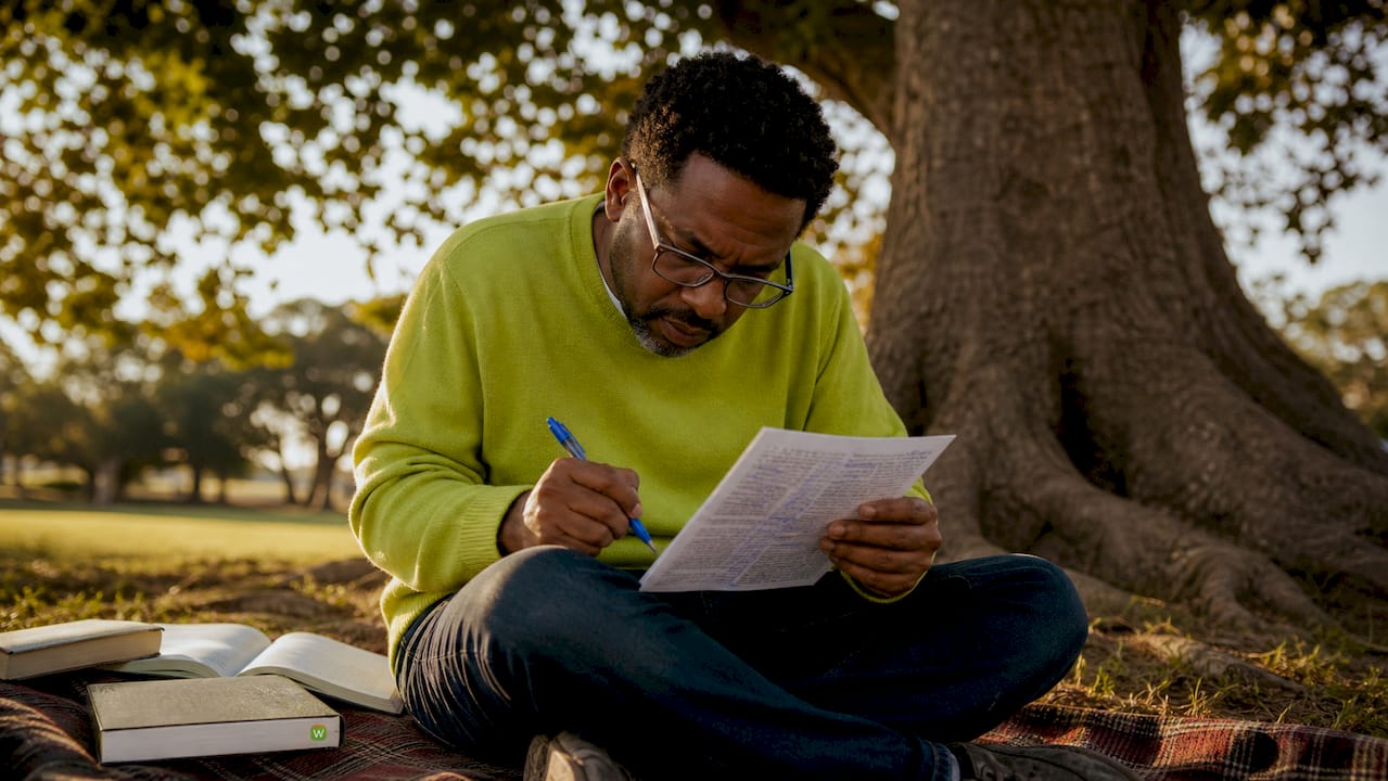 Man annotating printed text during intensive reading