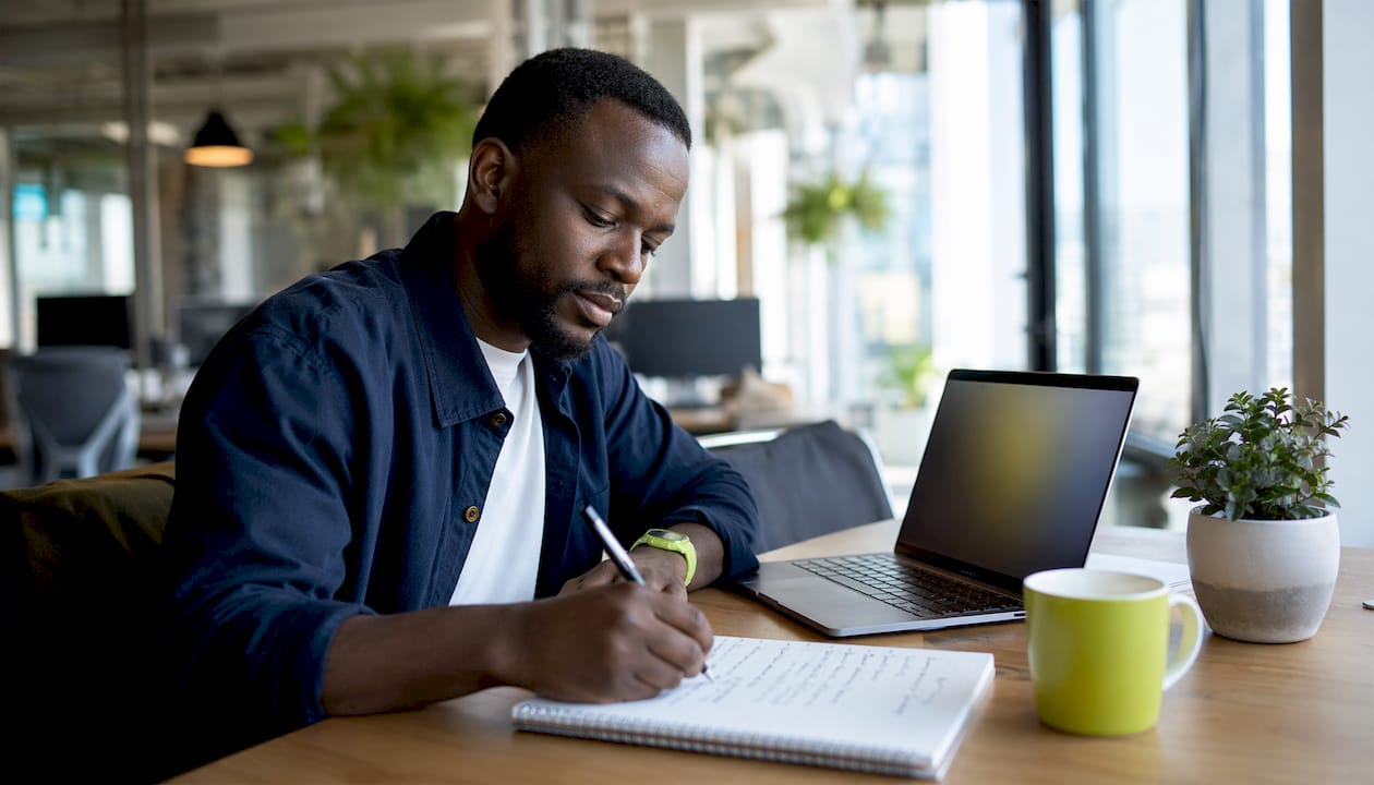 Man preparing vocabulary notes at coffee shop
