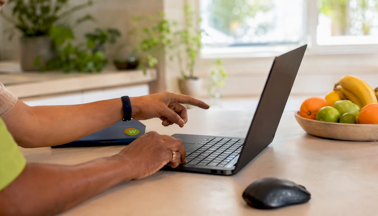 Hands configuring translate subtitle extension on computer