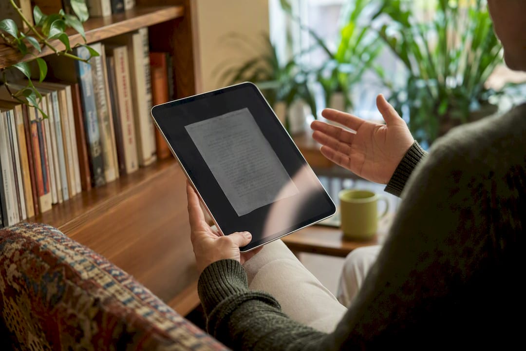 Hands interacting with tablet for OCR translation