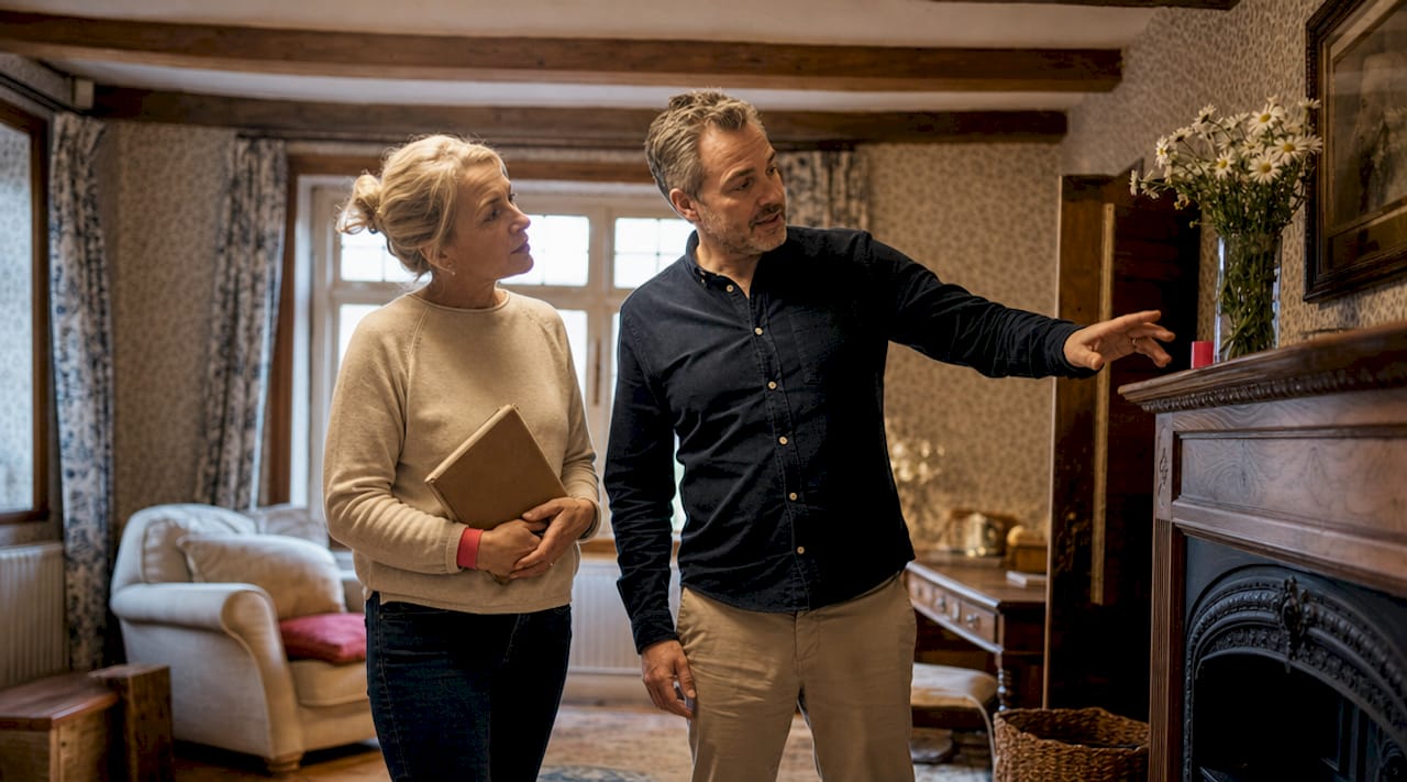 Couple touring renovated rental home interior