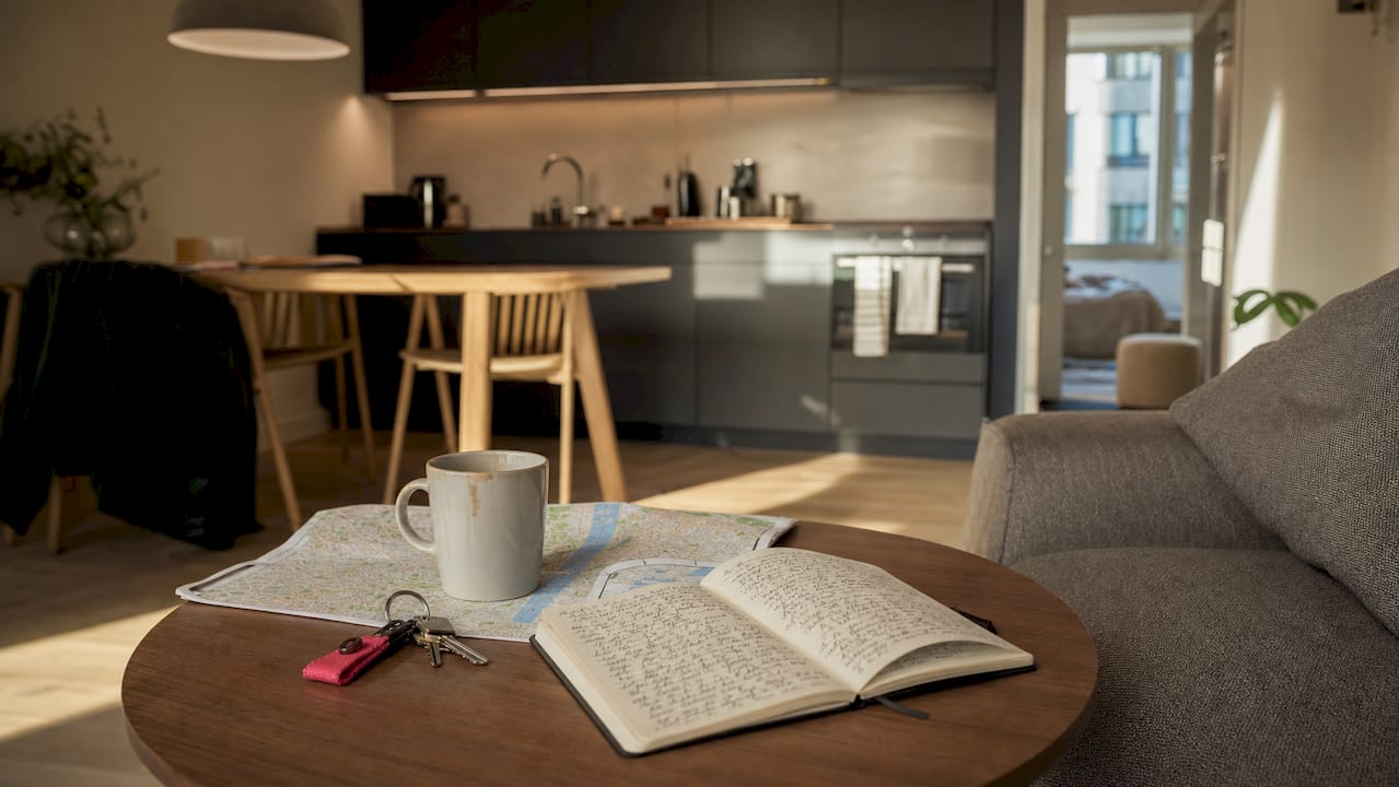 Desk with travel documents and kitchenette background