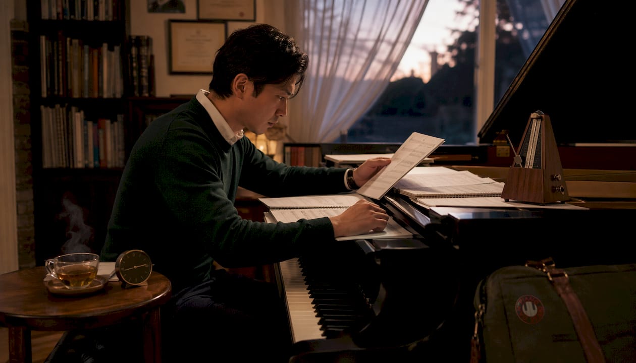 Pianist studying ABRSM marking scheme documents