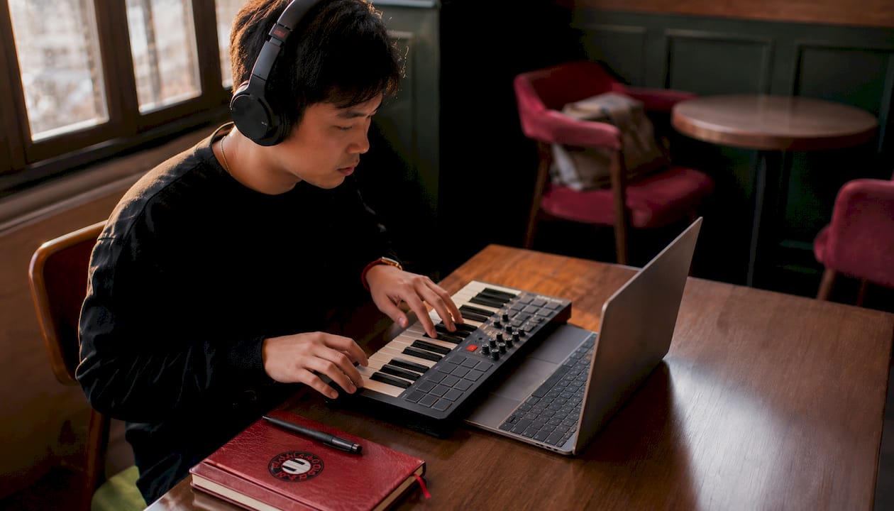Music producer using ear training web app in studio