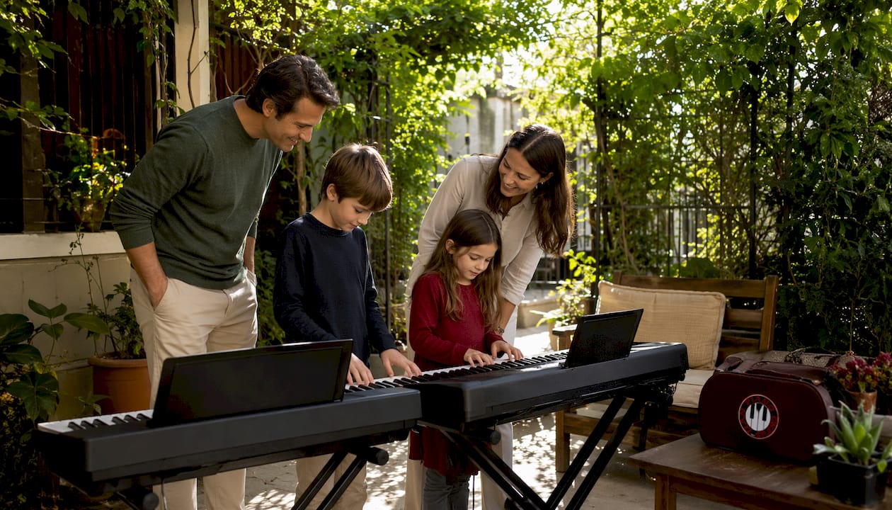 Family comparing digital piano and keyboard at home