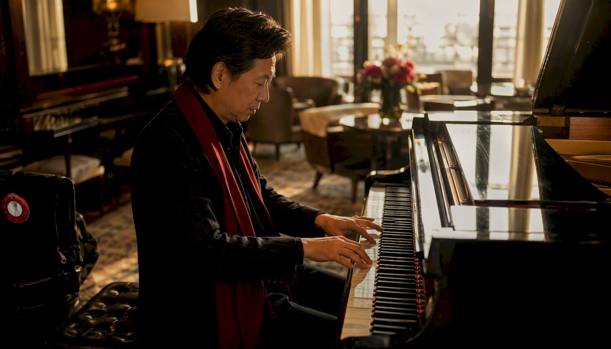 Pianist playing guide-tone voicings on grand piano