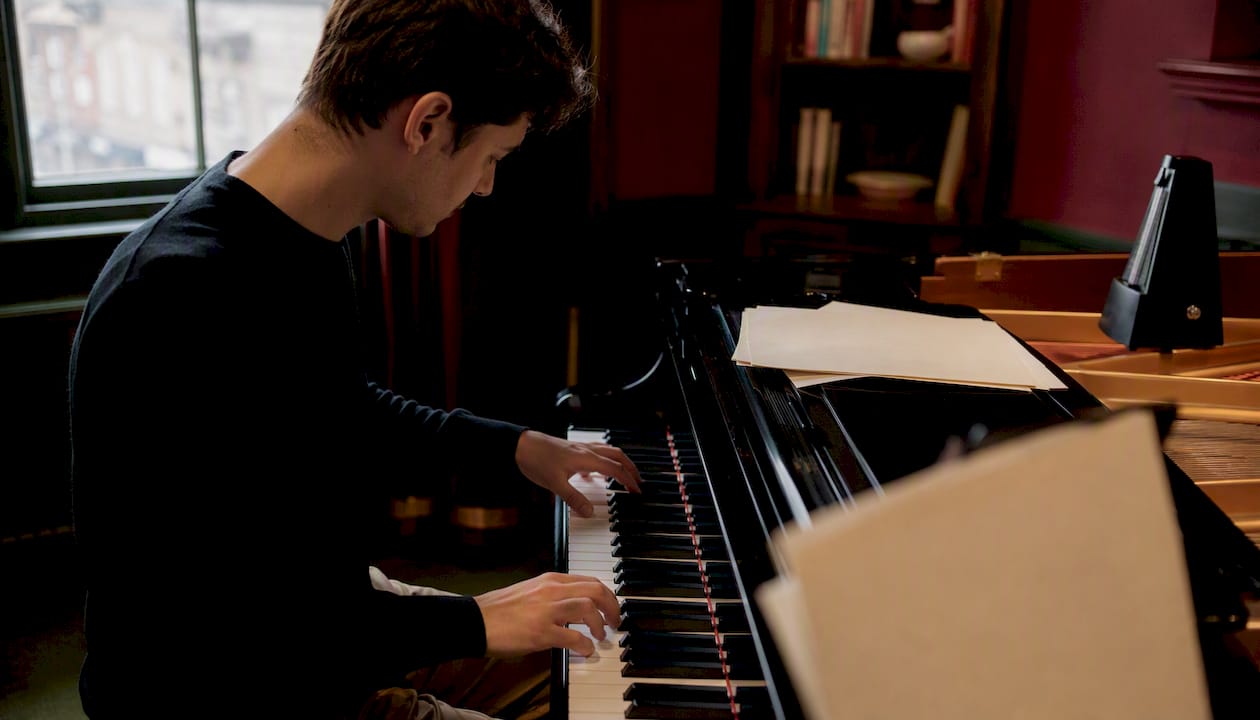 Pianist practicing beginner piano pieces